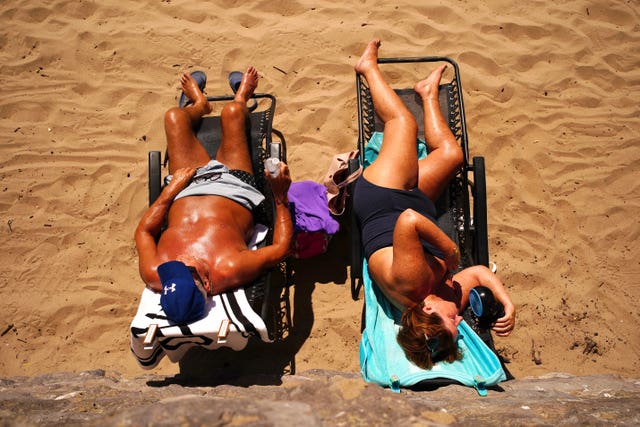 People on the beach at Barry Island, Wales, enjoying the hot weather