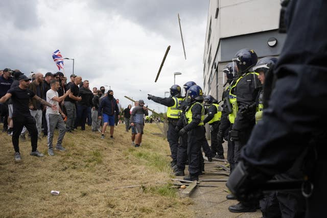 Violent protesters hurl objects and missiles at police guarding Holiday Inn Express, Rotherham