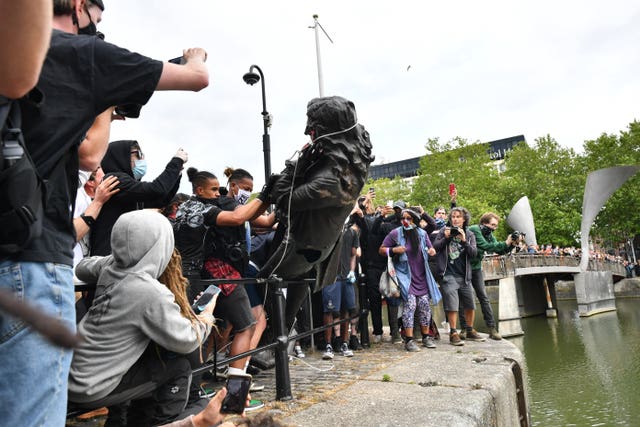 Protesters throw statue of Edward Colston into Bristol harbour (Ben Birchall/PA Wire)