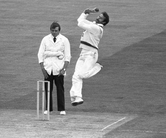 Umpire Dickie Bird watches the feet as Australian fast bowler Dennis Lillee explodes into action at the crease