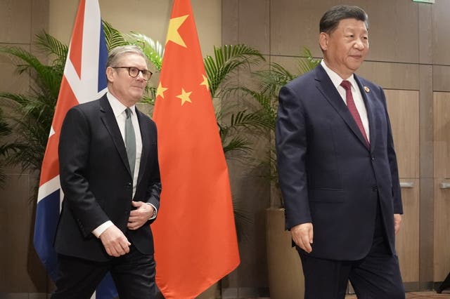 Sir Keir Starmer walks alongside Xi Jinping