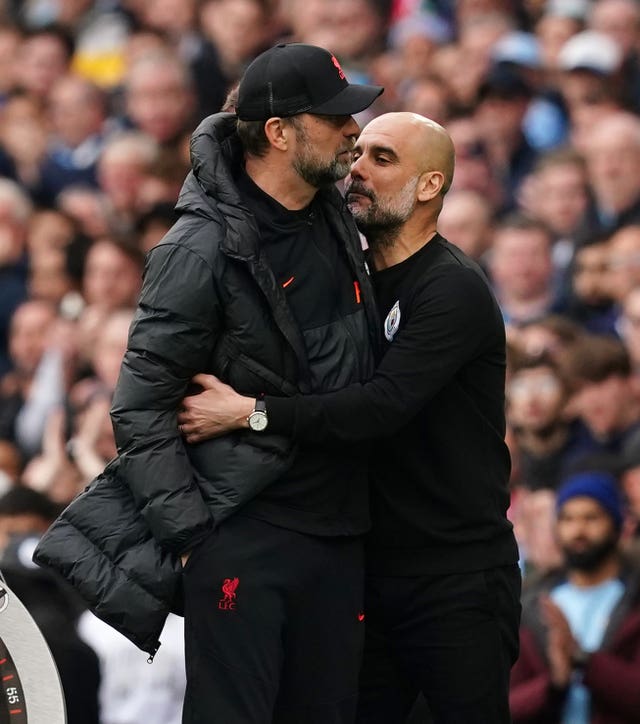 Manchester City manager Pep Guardiola embraces Liverpool manager Jurgen Klopp 