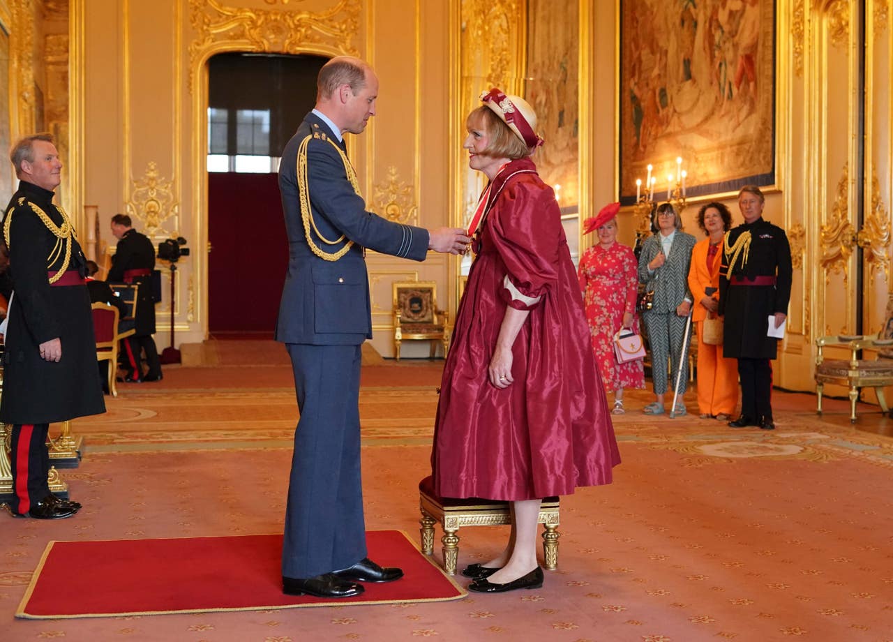 Grayson Perry accepts knighthood in burgundy taffeta dress in honour of ...