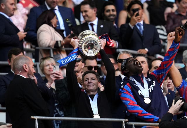 Crystal Palace manager Oliver Glasner lifts the FA Cup while wearing his 'lucky' black jumper