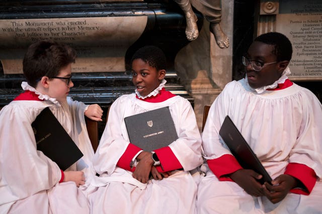 Boy choristers in their robes holding their hymn books