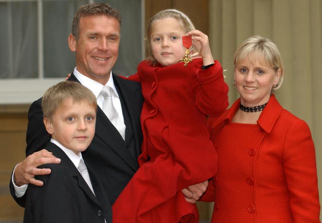 Former England and Surrey cricketer Alec Stewart with his wife Lynn and children Andrew and Emily after he received an OBE in 2003