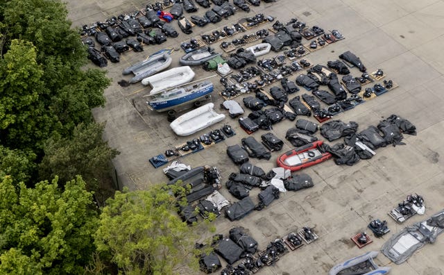 An aerial view of small boats and outboard motors used by people thought to be migrants to cross the Channel from France at a warehouse facility in Dover 
