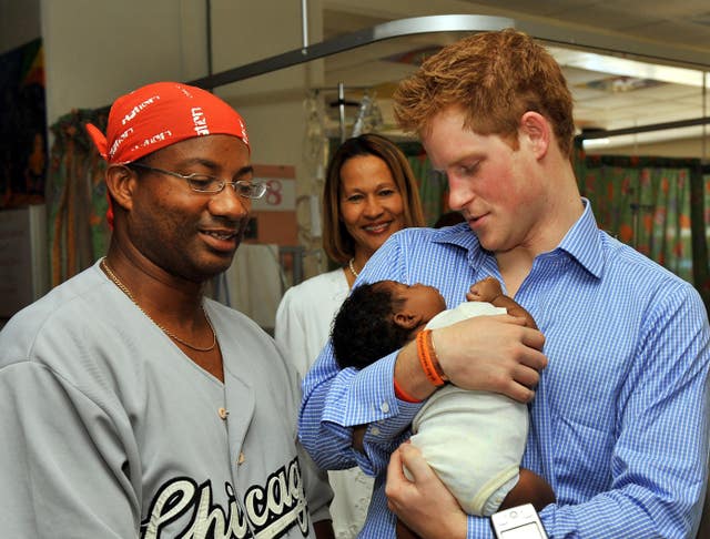 The Duke of Sussex has made a number of official visits to Barbados over the years and is pictured in 2010 holding Jean-Luc Jordan aged 7 weeks, with father Michael (left), at the Queen Elizabeth II Hospital in the capital Bridgetown. Arthur Edwards/PA Wire