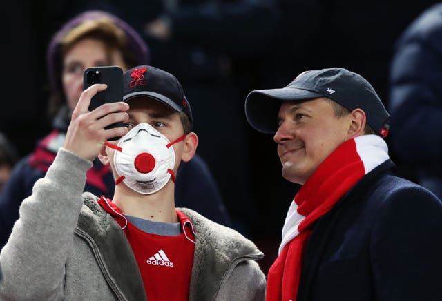 A Liverpool fan wearing a protective mask 