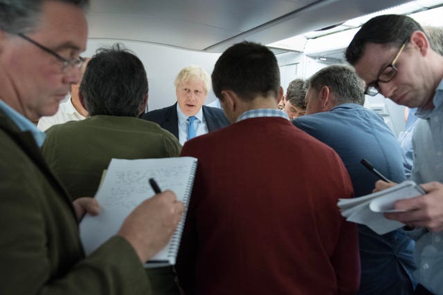 Boris Johnson speaking to reporters on his flight to New York