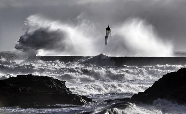 Waves crash over Seaham lighthouse near Durham 