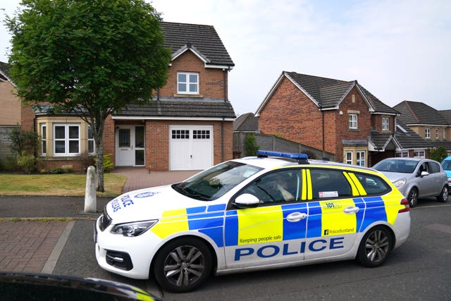 Police car outside a house on a suburban street