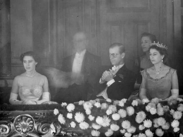 Princess Margaret, Prince Philip the Duke of Edinburgh, and Queen Elizabeth II watching the Royal Command Variety Performance in 1953 