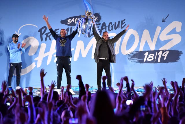 Captain Vincent Kompany and manager Pep Guardiola on stage with the trophy at Manchester City's 2018-19 title celebration