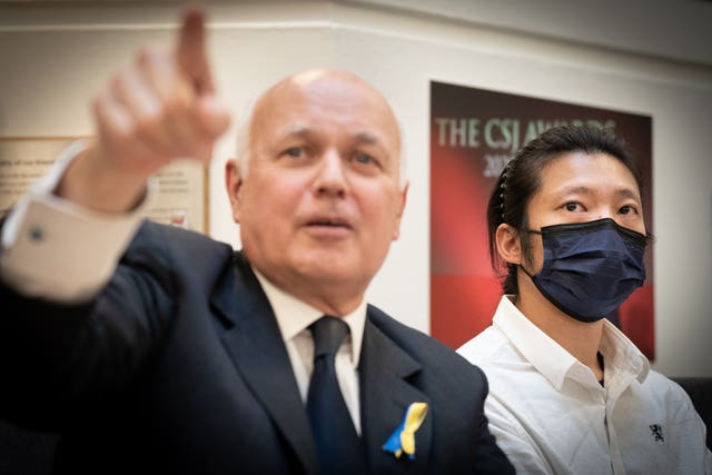 Bob Chan (right), the Hong Kong protester allegedly assaulted at the Chinese consulate in Manchester, with Conservative MP Iain Duncan Smith at a press conference in central London