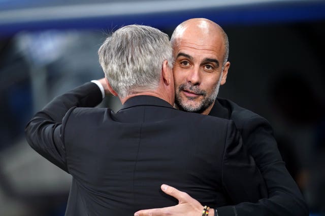 Pep Guardiola, right, embraces Real Madrid manager Carlo Ancelotti 