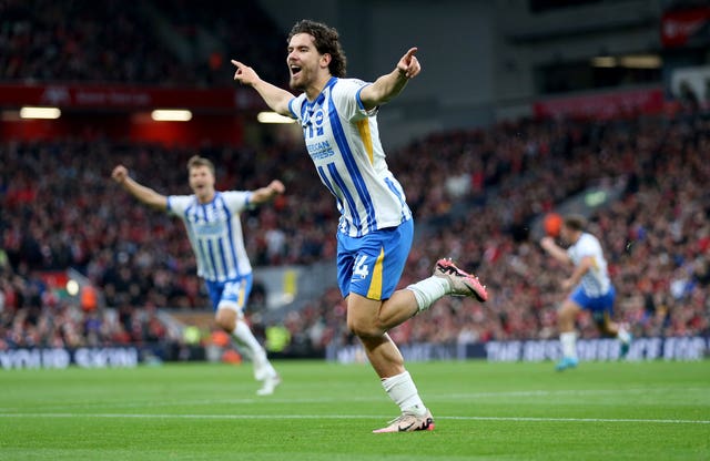 Ferdi Kadioglu runs to celebrate with his arms aloft