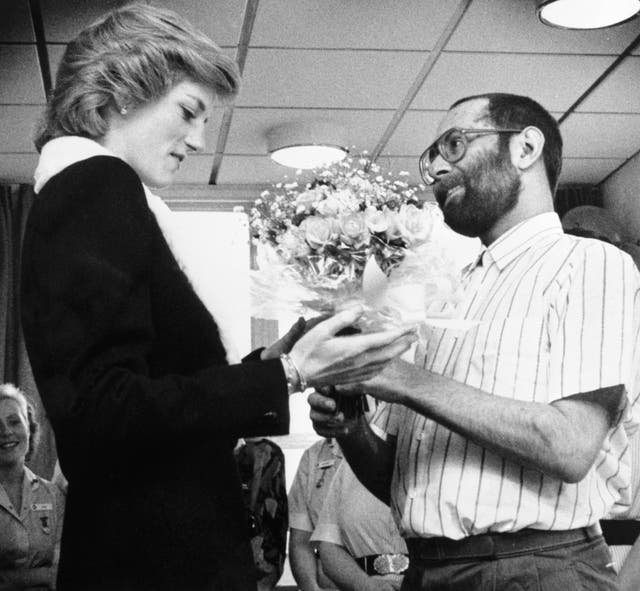 The Princess of Wales is presented with a bouquet by AIDS patient Martin Johnson during her visit to the Mildmay Mission Hospital AIDS Hospice in East London