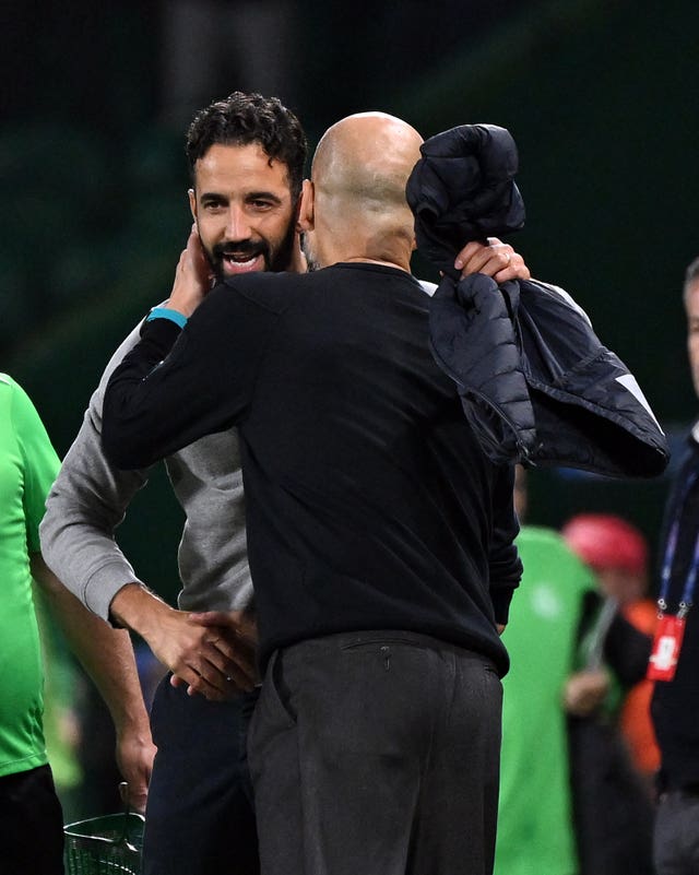 Manchester City manager Pep Guardiola and Sporting Lisbon manager Ruben Amorim embrace each other