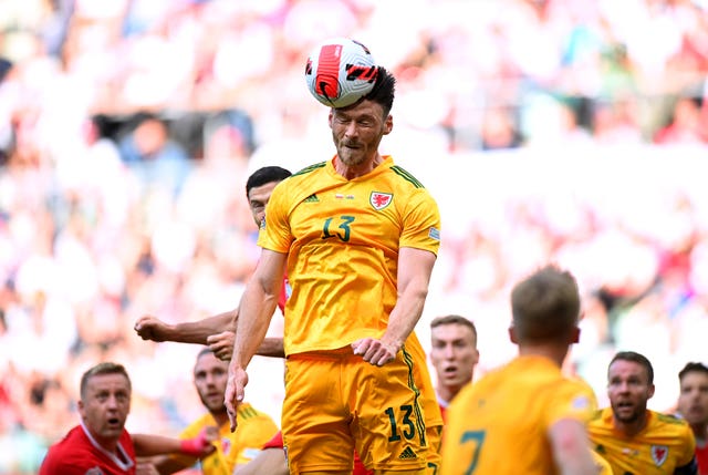 Kieffer Moore heads the ball 