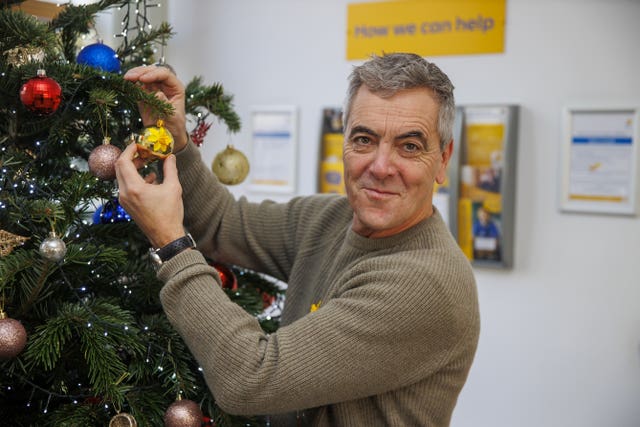 Actor James Nesbitt helping to put up decorations of a Christmas tree during a visit to the Marie Curie Hospice in Belfast