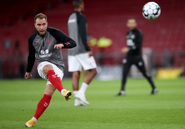Denmark’s Christian Eriksen warms up on the pitch