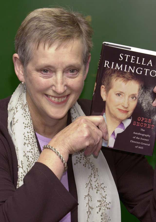Dame Stella Rimington holding a copy of her autobiography