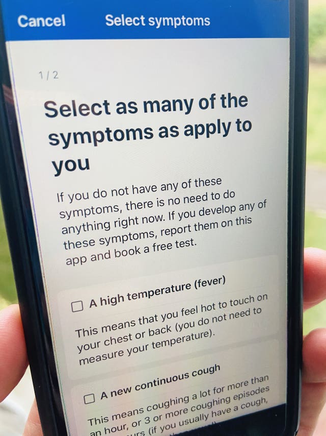 A person using the NHS Covid-19 app (Scott D'Arcy/PA)