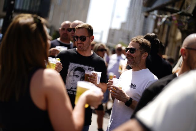 Oasis fans enjoying a drink in the Cardiff sunshine