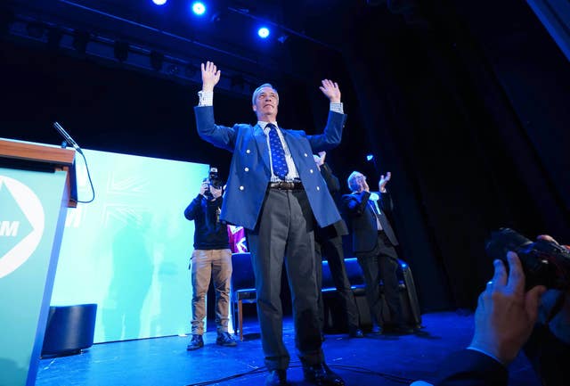 Reform UK leader Nigel Farage with his hands in the air after speaking at Princes Theatre in Clacton