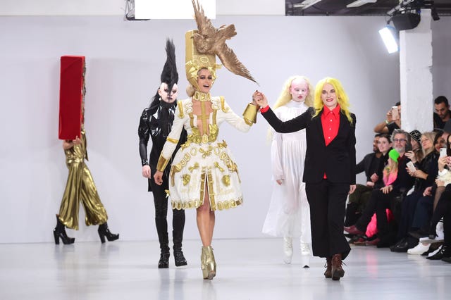 Pam Hogg holding hands with a model while walking down a catwalk