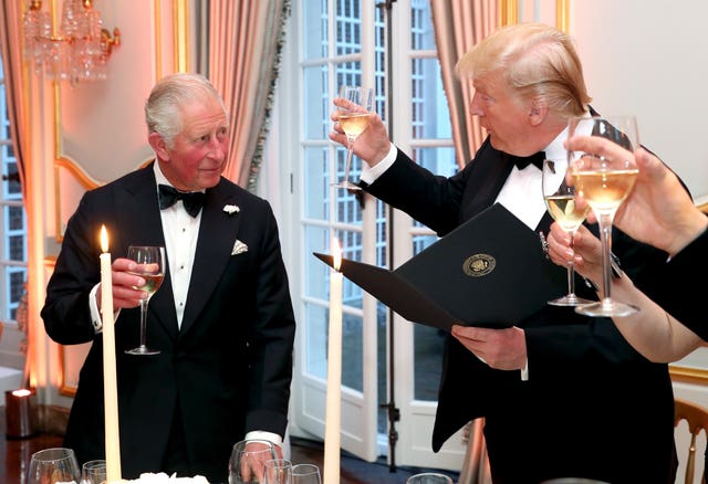 US President Donald Trump raises his glass to the then-Prince of Wales during the toast at the Return Dinner at Winfield House in 2019