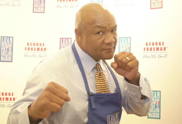 Former boxing heavyweight world champion George Foreman poses with his fists up at a media event in London