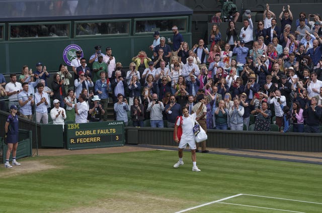 Roger Federer waves goodbye to the Wimbledon crowd for the final time after he suffered a last-eight exit to Hubert Hurkacz 