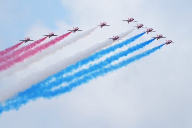 The Red Arrows display team perform a flypast 