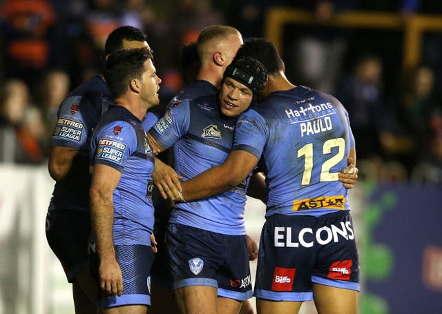 Jonny Lomax (centre) celebrates scoring St Helens' eighth try in the crushing 42-12 win over Castleford on Friday night