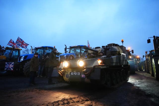 Farmers and their tractors and a tank at Belmont Farm in north London