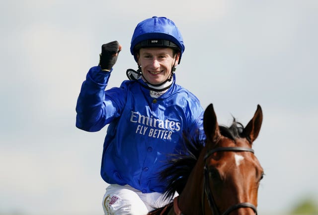 Jockey Oisin Murphy celebrates on board Mawj after winning the 1000 Guineas Stakes 