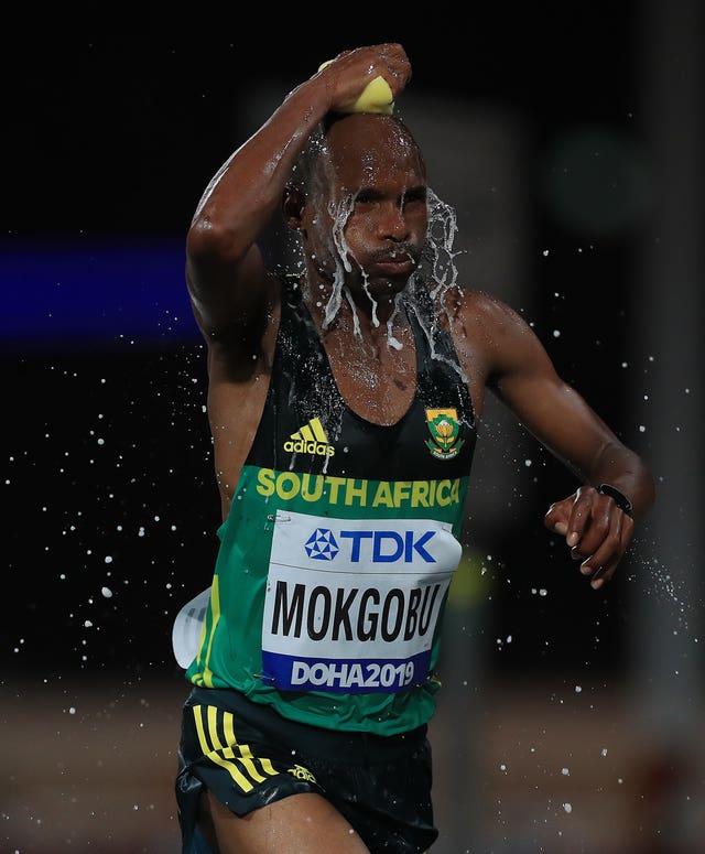 South Africa's Desmond Mokgobu cools off during the men's marathon on day nine of the World Athletics Championships in Doha. The competition, held in September and October, attracted criticism due to a lack of spectators, flat atmosphere, heat, and the timing of events. Mokgobu finished the event down in 32nd place, with Ethiopia's Lelisa Desisa claiming gold