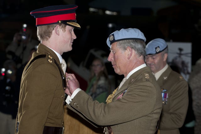 Prince Harry receiving his Flying Wings from his father, the Prince of Wales, during a graduation ceremony from an advanced helicopter training course (Jamie Wiseman/PA)
