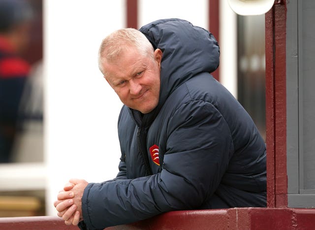 Anthony McGrath, leaning on a railing, looks to his left and smiles