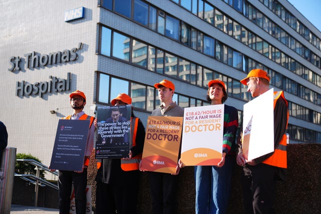 NHS resident doctors holding placards outside St Thomas’ Hospital in London