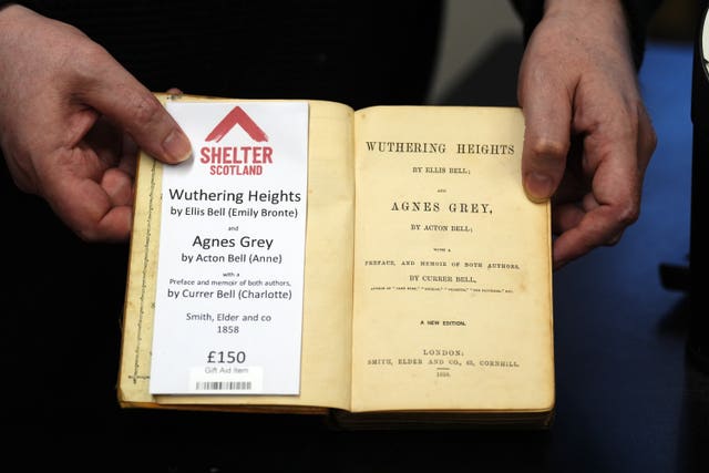 Hands holding an open copy of Wuthering Heights