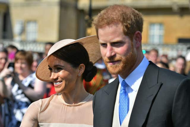 Newlywed Harry and Meghan in 2018 at a Buckingham Palace garden party