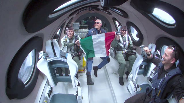 Italian Air Force Colonel Walter Villadei holding up an Italian flag