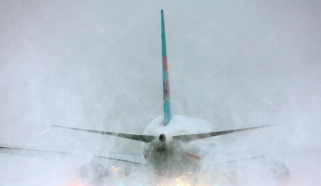 A plane throws up clouds of snow as it prepares for take off at Gatwick Airport in 2010 (Gareth Fuller/PA)