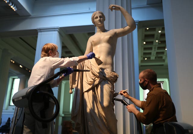 Sovati Smith (left) and Alex Truscott from the collections team dusting the Townley Venus Roman sculpture (1st or 2nd century AD) (Yui Mok/PA)