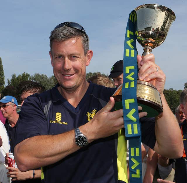Then Warwickshire coach Ashley Giles celebrates with the County Championship trophy