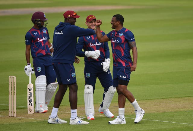 Shannon Gabriel (right) celebrates taking the wicket of John Campbell