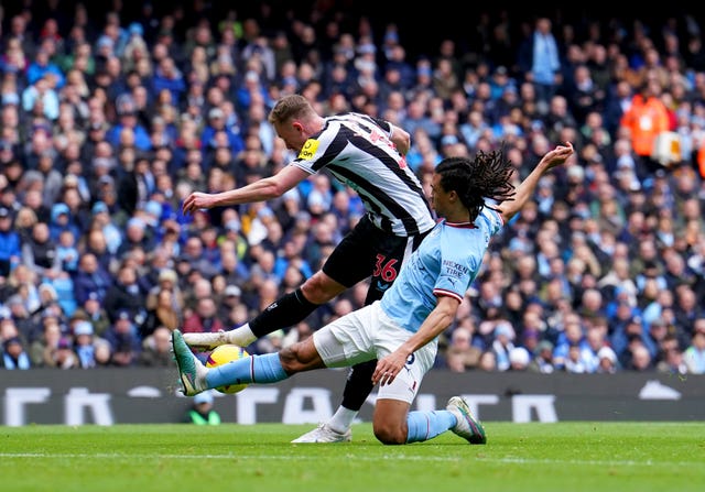 Nathan Ake, right, slides in to prevent Newcastle’s Sean Longstaff getting a shot away